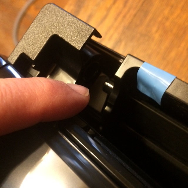 Pop the scanner from its hinge. Be careful not to tear the ribbon cable under this hinge!